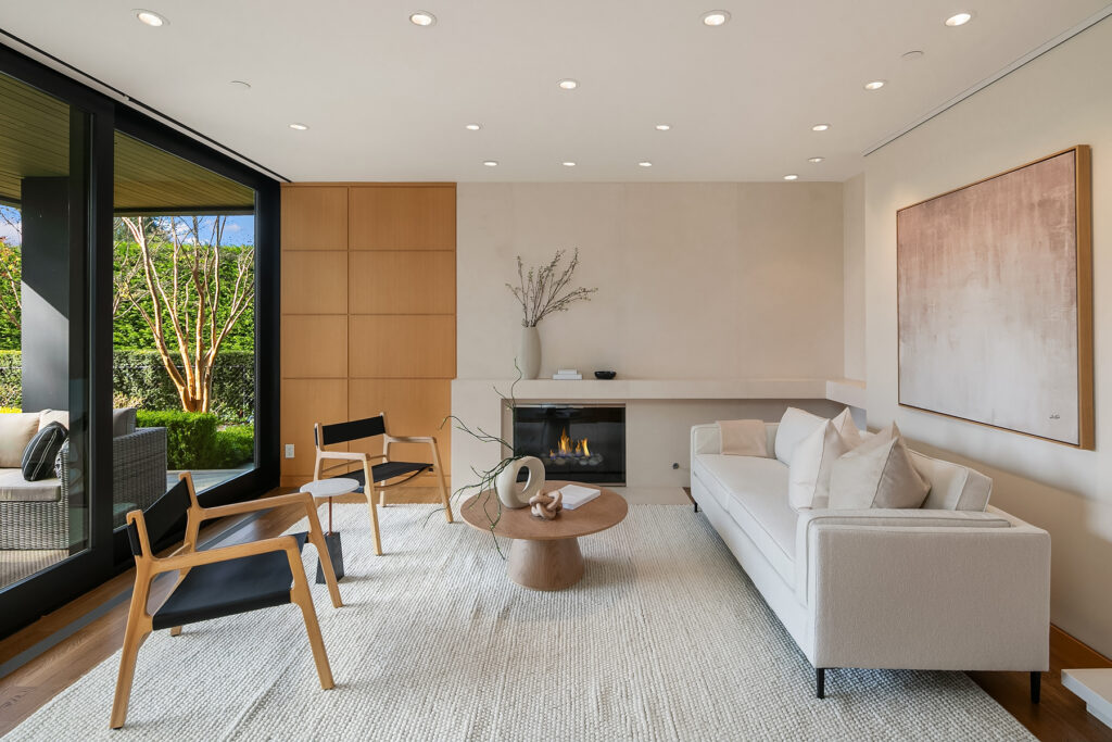 Wabi Sabi Modern living room with fireplace and garden view.